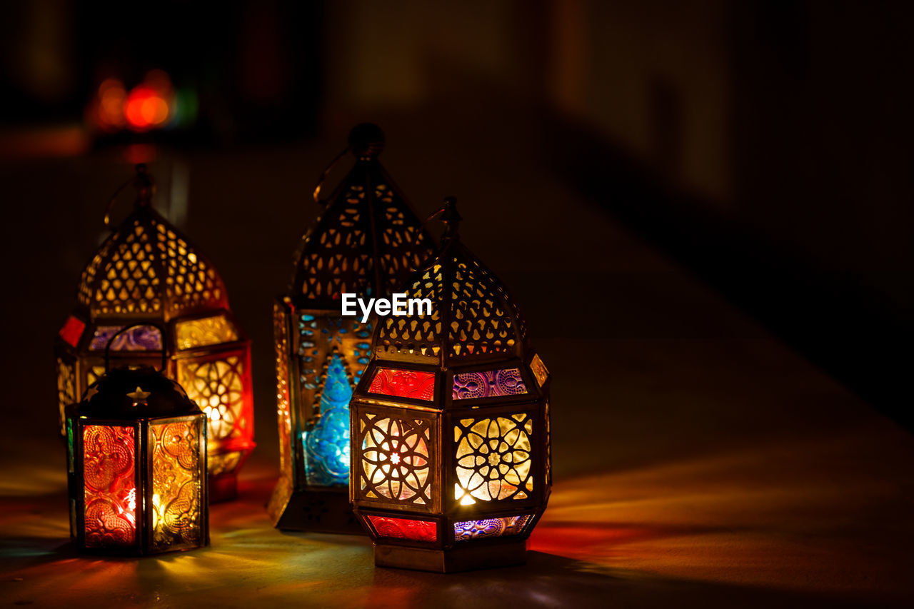 CLOSE-UP OF ILLUMINATED LANTERNS