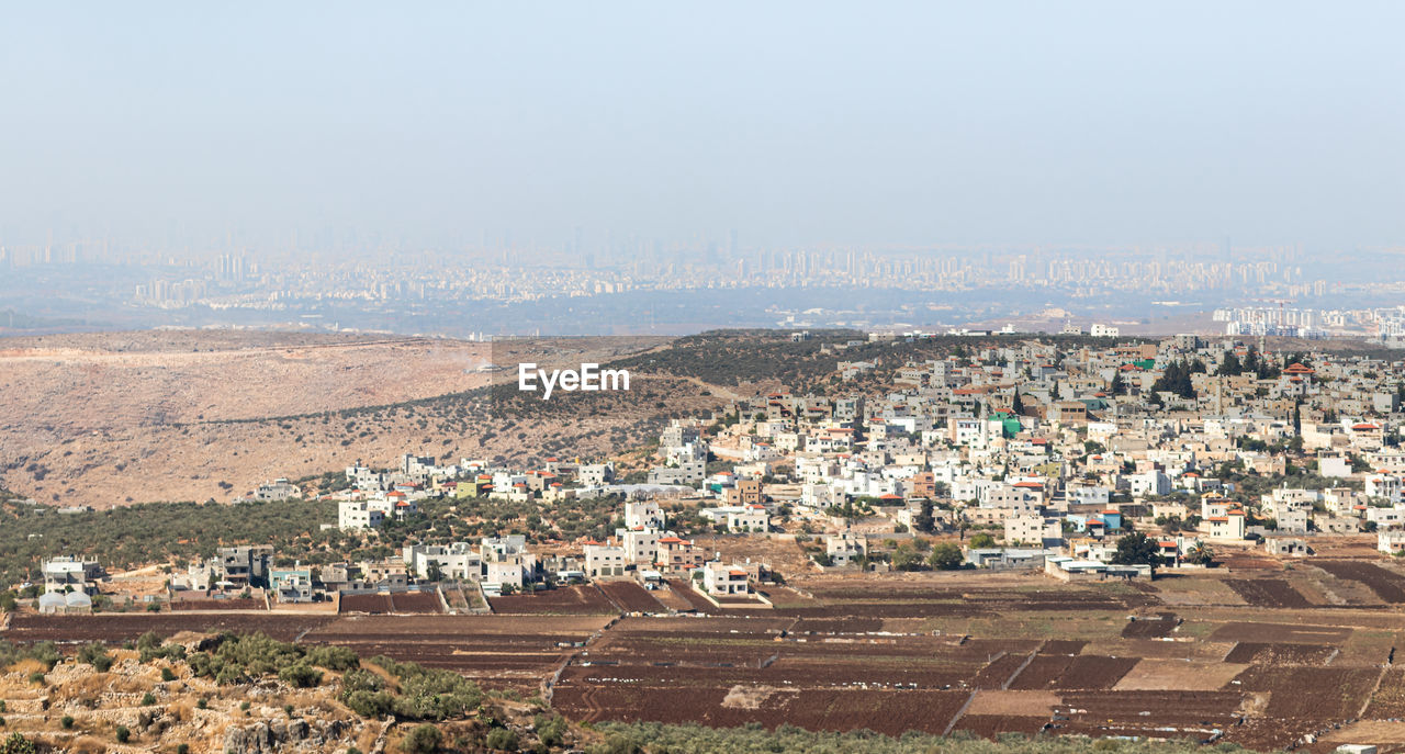 HIGH ANGLE VIEW OF HOUSES AND BUILDINGS IN CITY