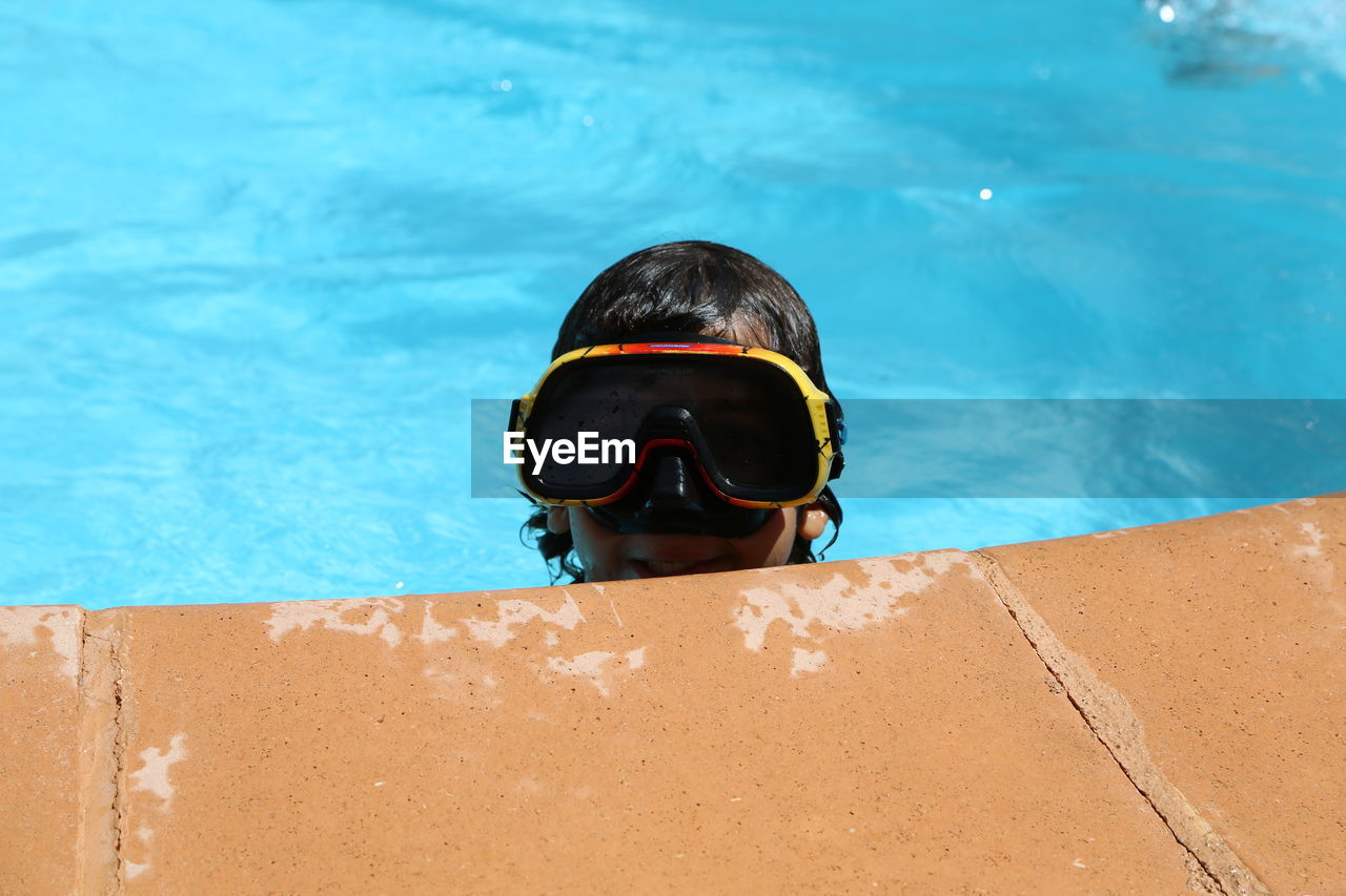 Close-up of boy swimming in pool