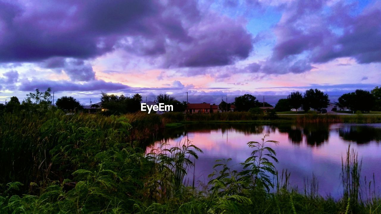 SCENIC VIEW OF LAKE AGAINST CLOUDY SKY