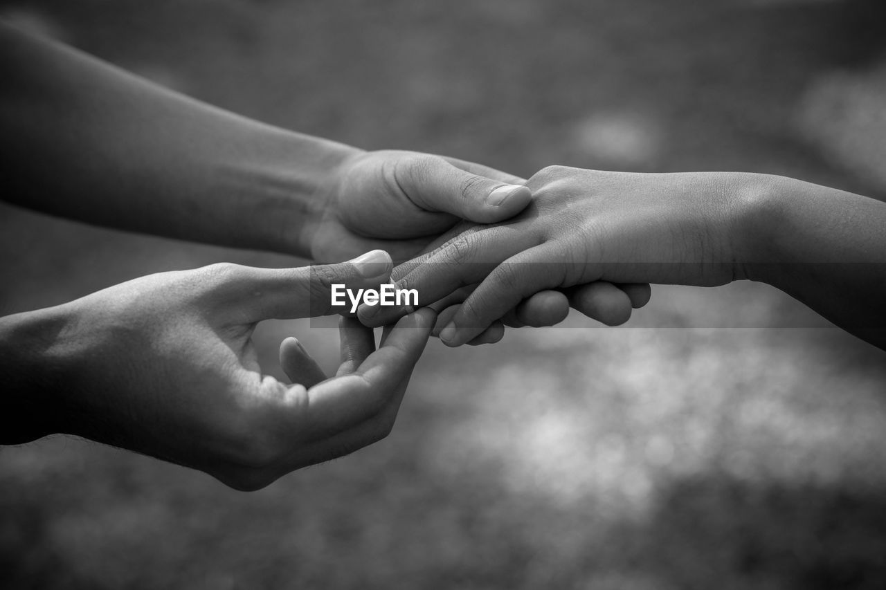 Midsection of couple holding hands