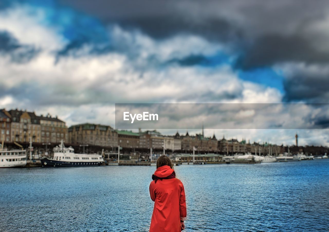 REAR VIEW OF MAN WITH RED UMBRELLA