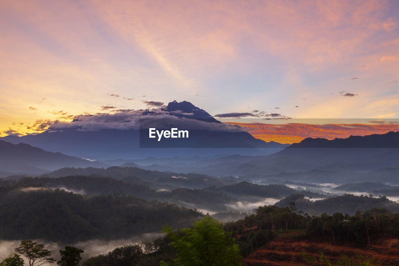 SCENIC VIEW OF MOUNTAIN AGAINST SKY DURING SUNSET