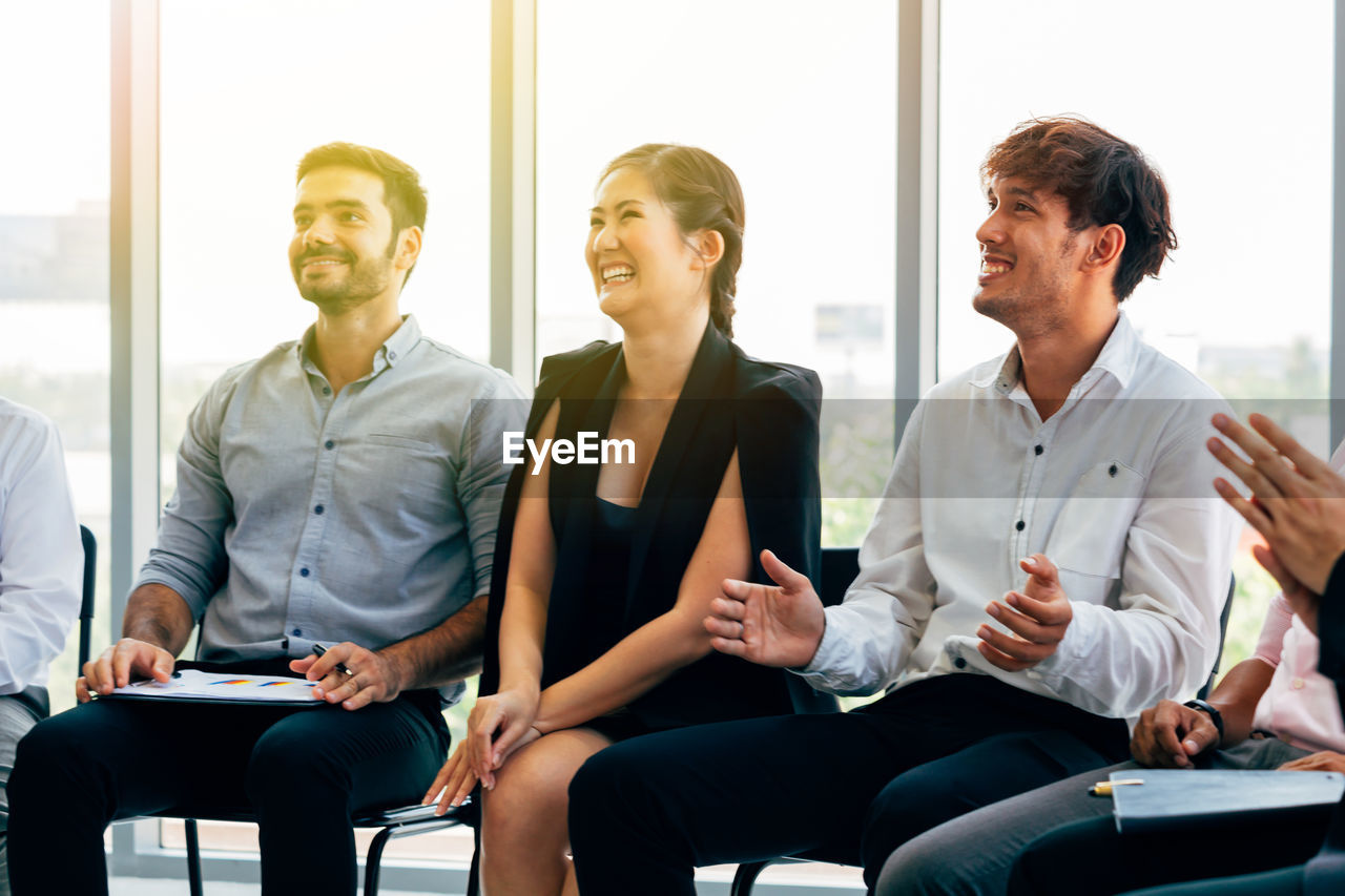 Smiling business colleagues sitting at office