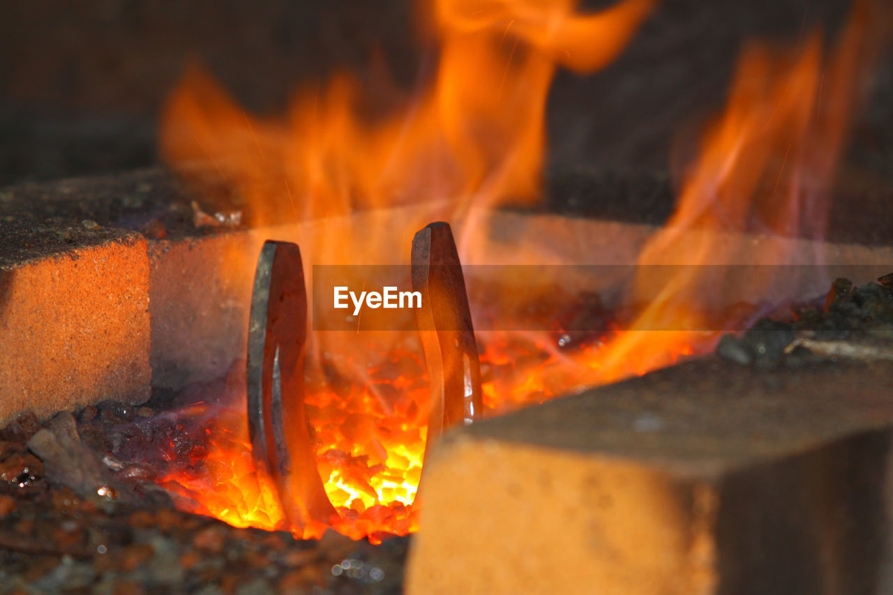Close-up of horseshoe burning in furnace
