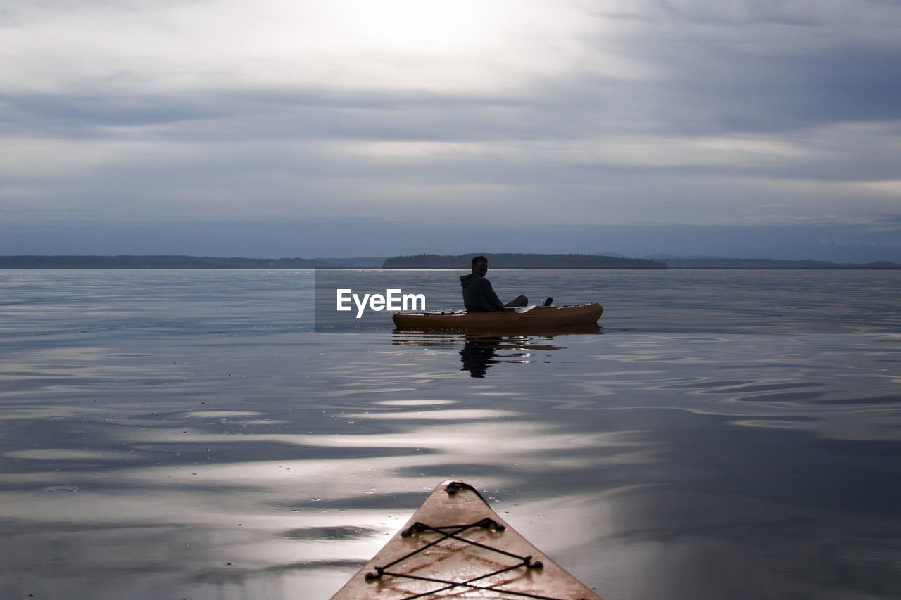 MEN IN SEA AGAINST SKY