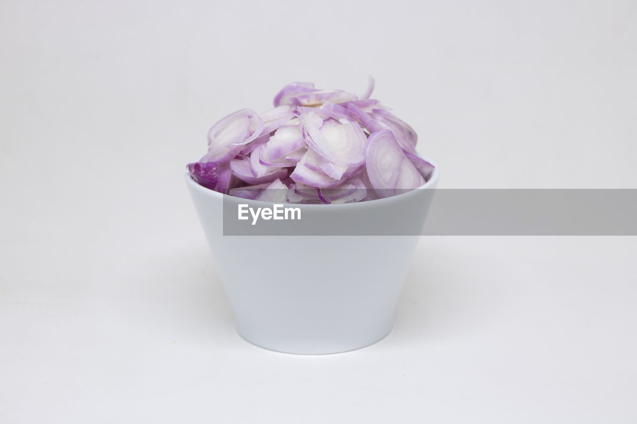 CLOSE-UP OF WHITE ROSES IN BOWL AGAINST BLACK BACKGROUND