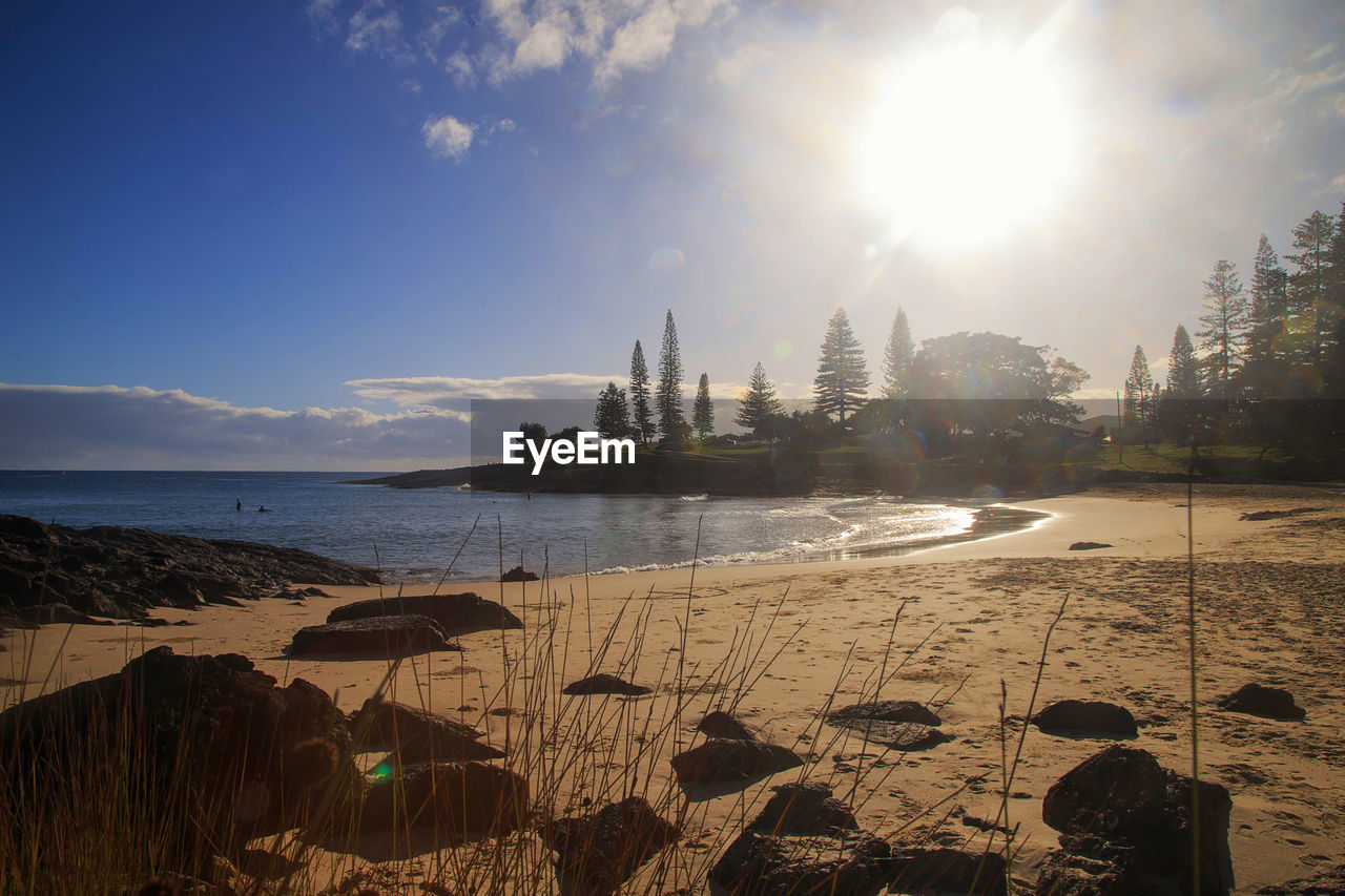 sky, water, morning, nature, sea, horizon, land, sunlight, sun, dusk, shore, beach, reflection, travel destinations, sunrise, body of water, coast, ocean, architecture, cloud, landscape, travel, wave, scenics - nature, beauty in nature, sunbeam, lens flare, environment, outdoors, built structure, tranquility, tourism, bay, no people, tree, building exterior, city, vacation, holiday, trip, sunny