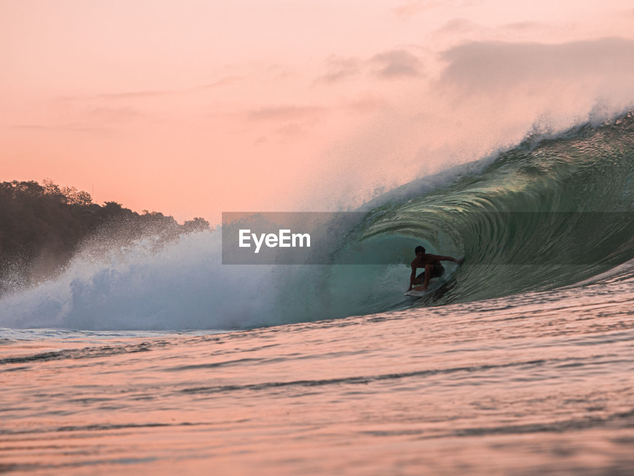 MAN SURFING IN SEA AGAINST SKY