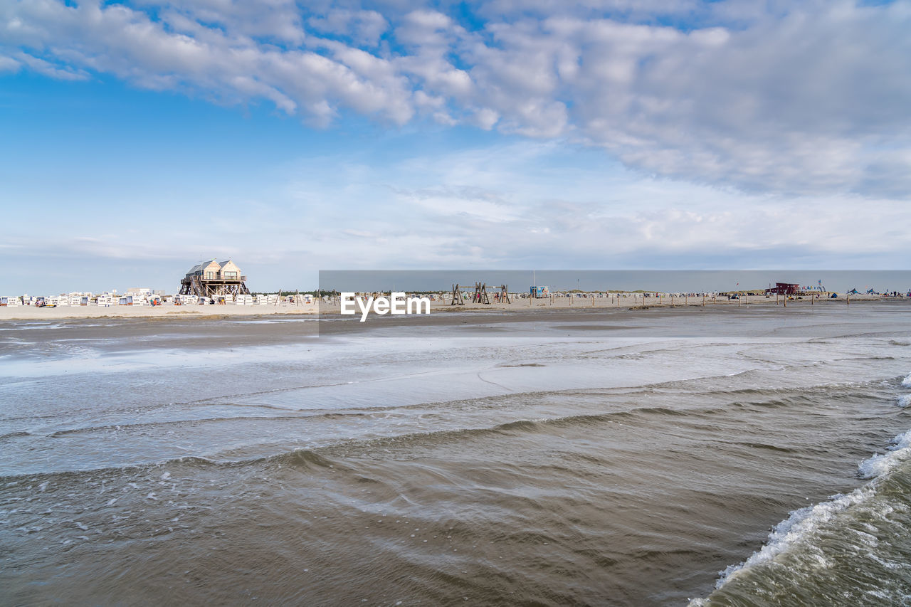 Scenic view of beach against sky in city