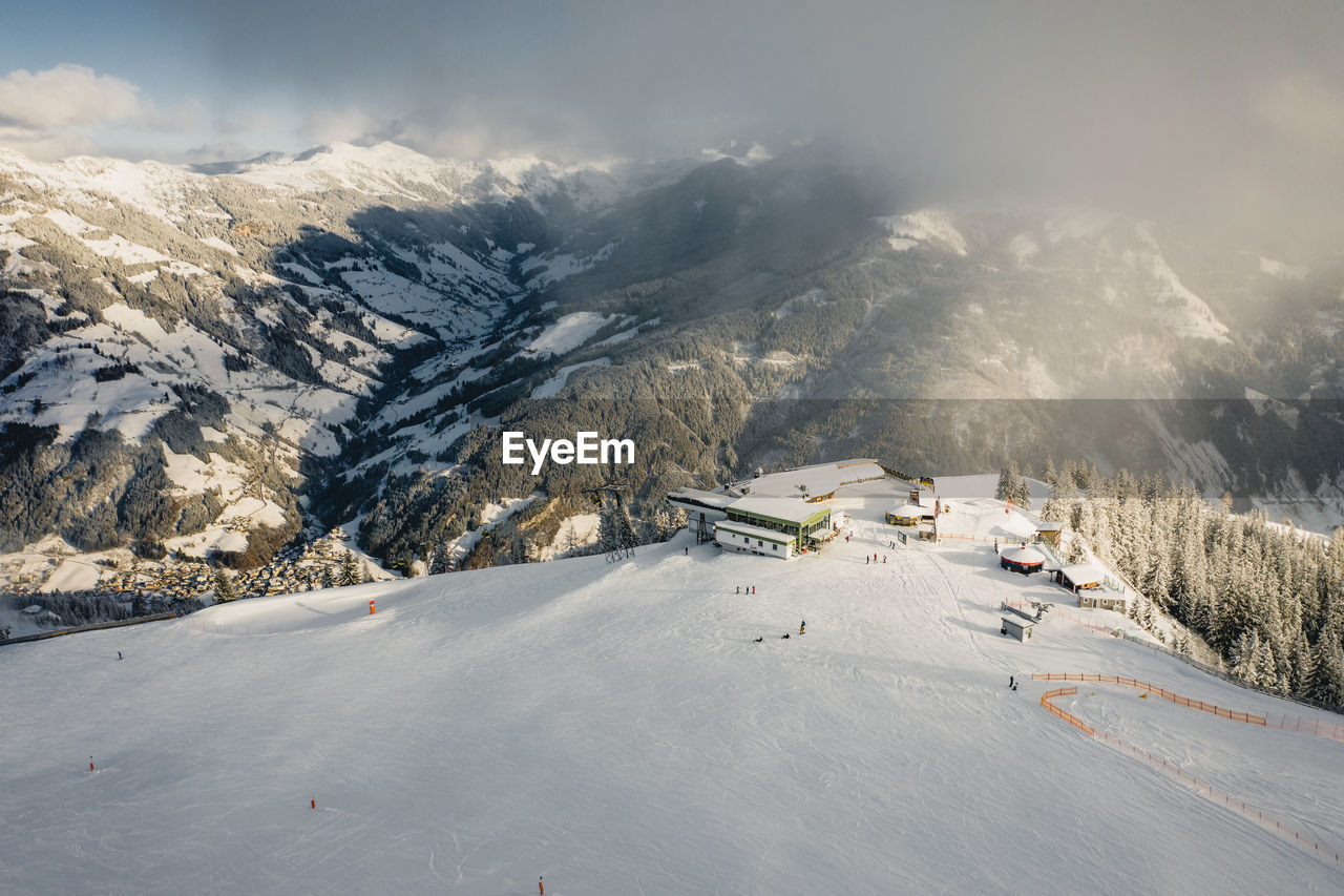 Skiers on empty slopes during covid-19 pandemic in the austrian alps.