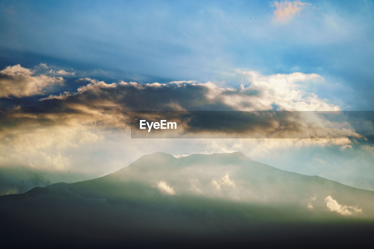 SCENIC VIEW OF MOUNTAINS AGAINST CLOUDY SKY