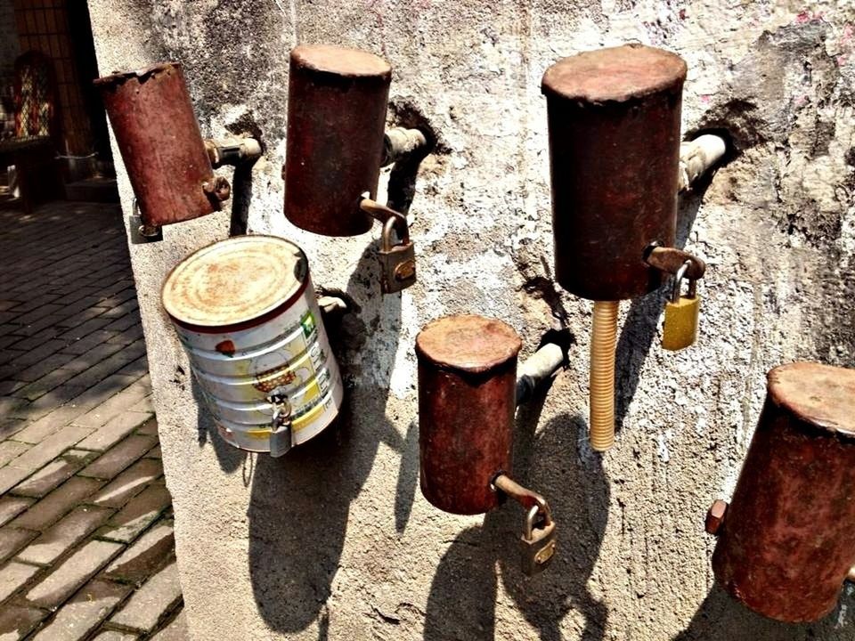 Rusty cans on wall