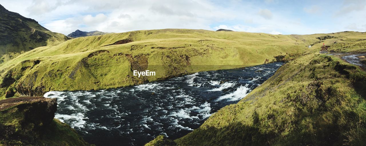 Scenic view of green landscape against sky