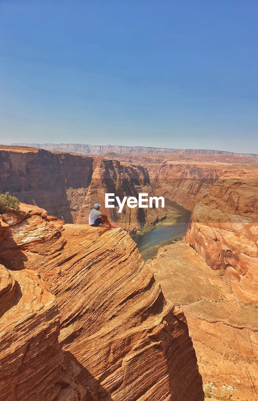 Scenic view of desert against clear blue sky