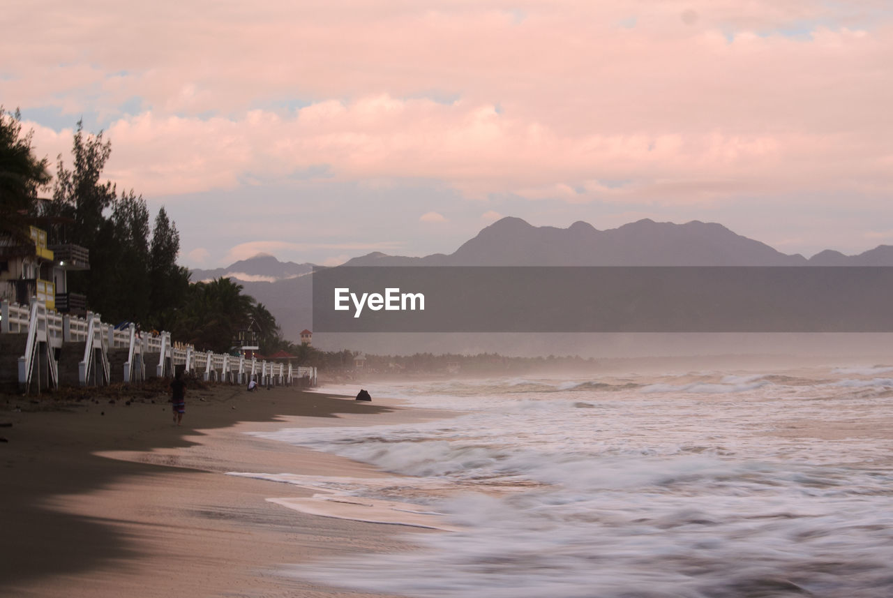 Scenic view of beach against sky during sunset