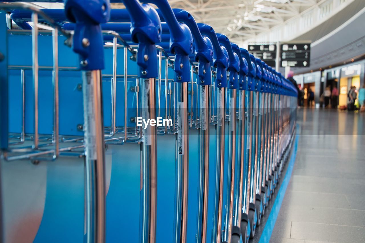 Close-up of blue luggage carts