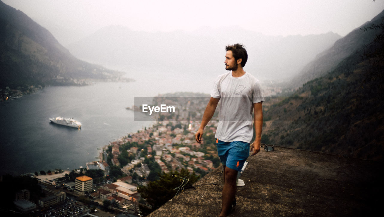 FULL LENGTH OF MAN STANDING ON MOUNTAIN