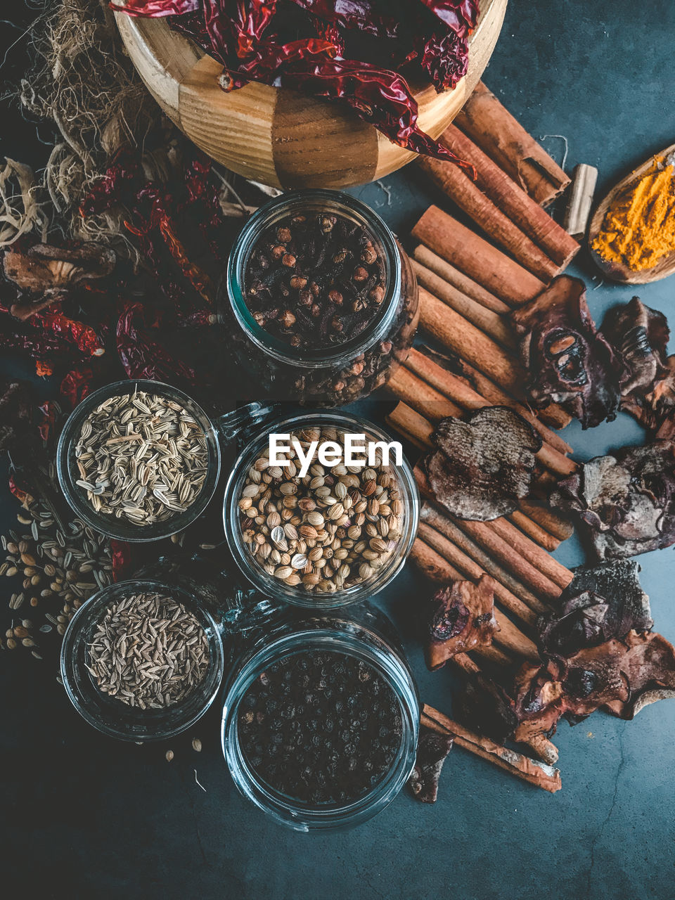 High angle view of spices and herbs on a black background 