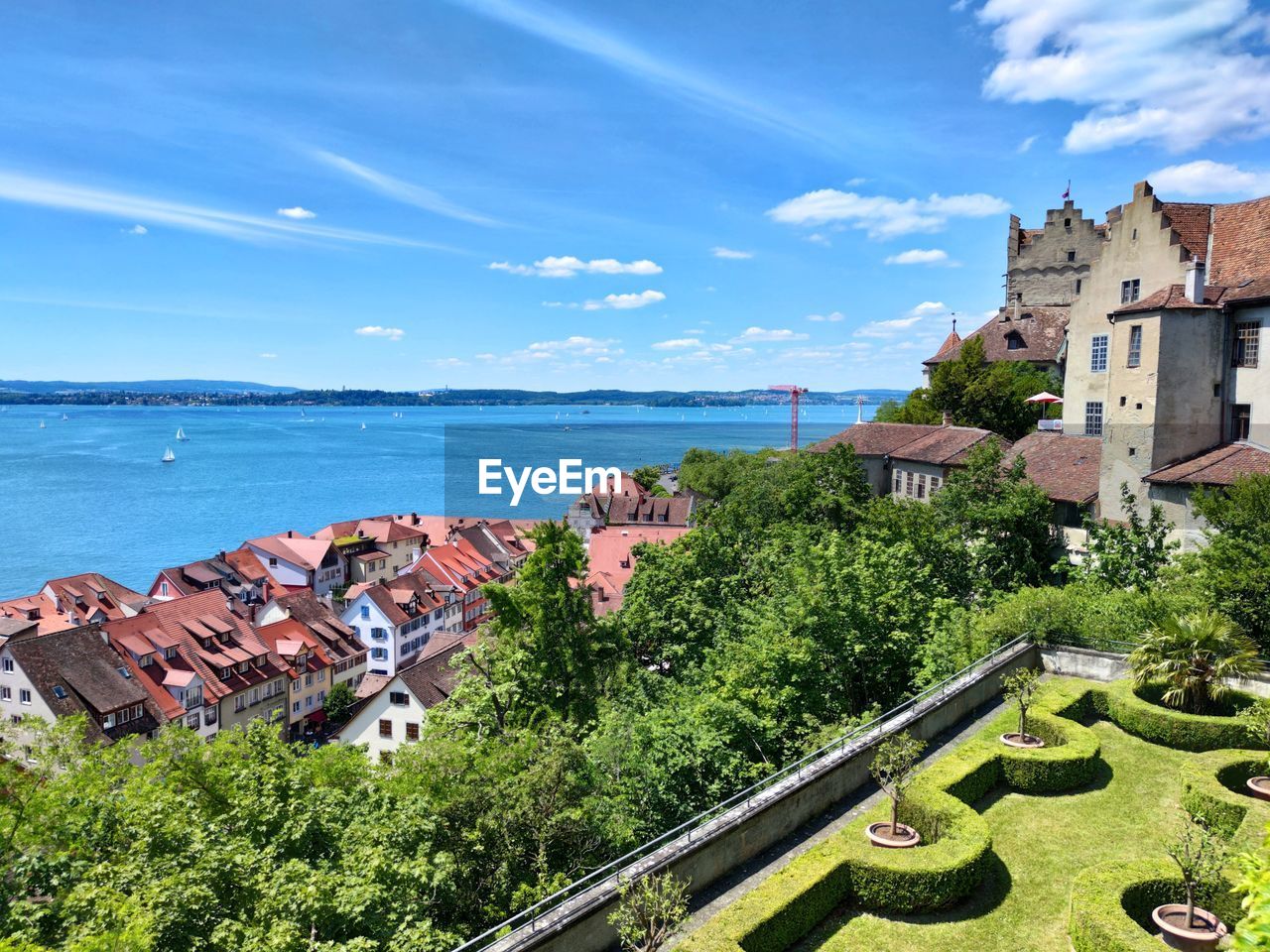 High angle view of buildings and sea against sky