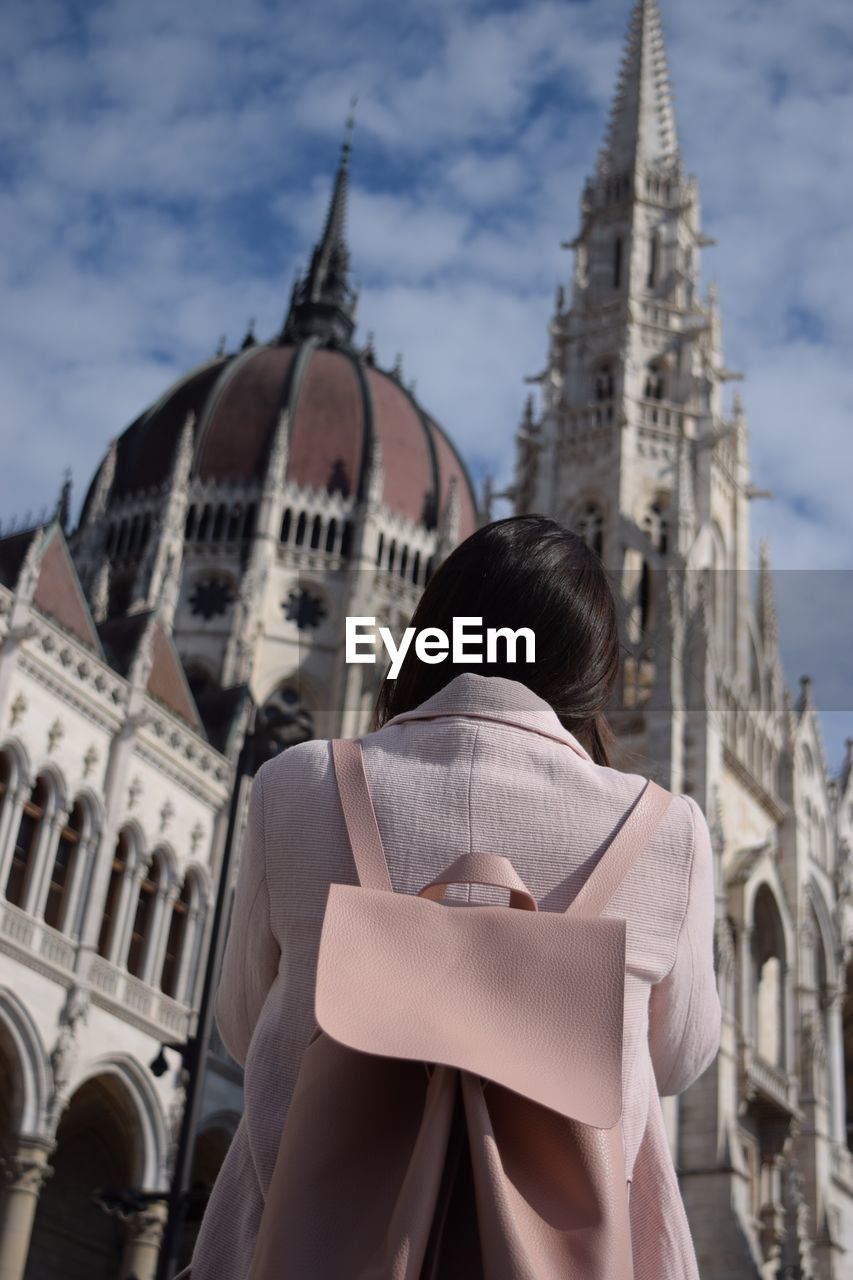 Rear view of woman against hungarian parliament building