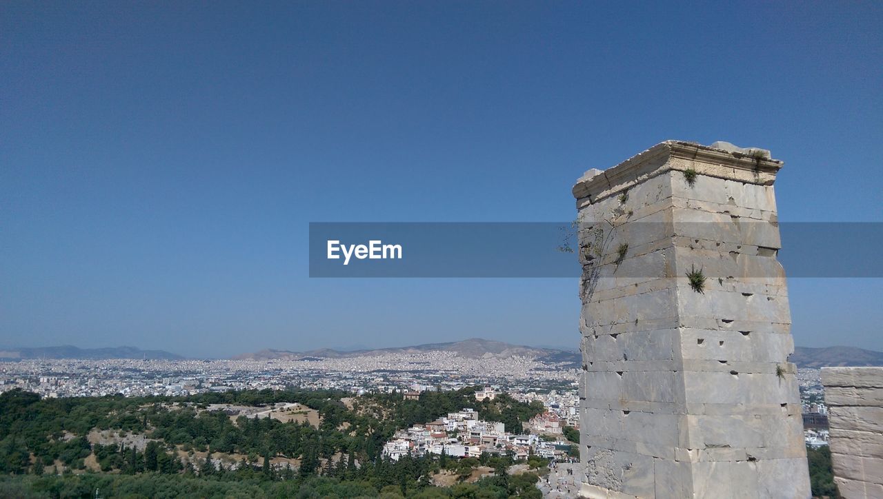 Old ruins on mountain against clear blue sky