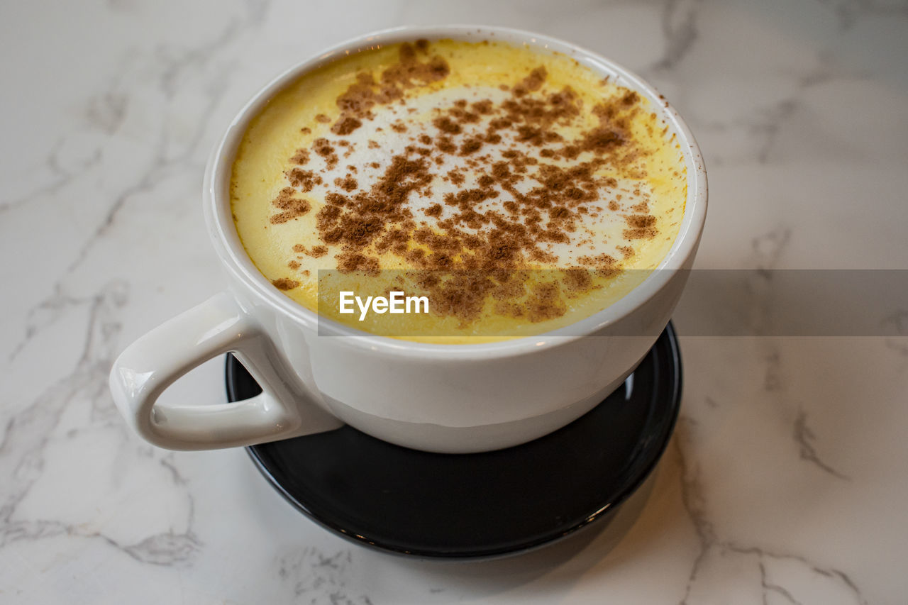 food and drink, coffee, drink, mug, cup, coffee cup, refreshment, cappuccino, hot drink, dish, food, crockery, frothy drink, latte, saucer, café au lait, still life, high angle view, indoors, no people, table, breakfast, dessert, heat, close-up