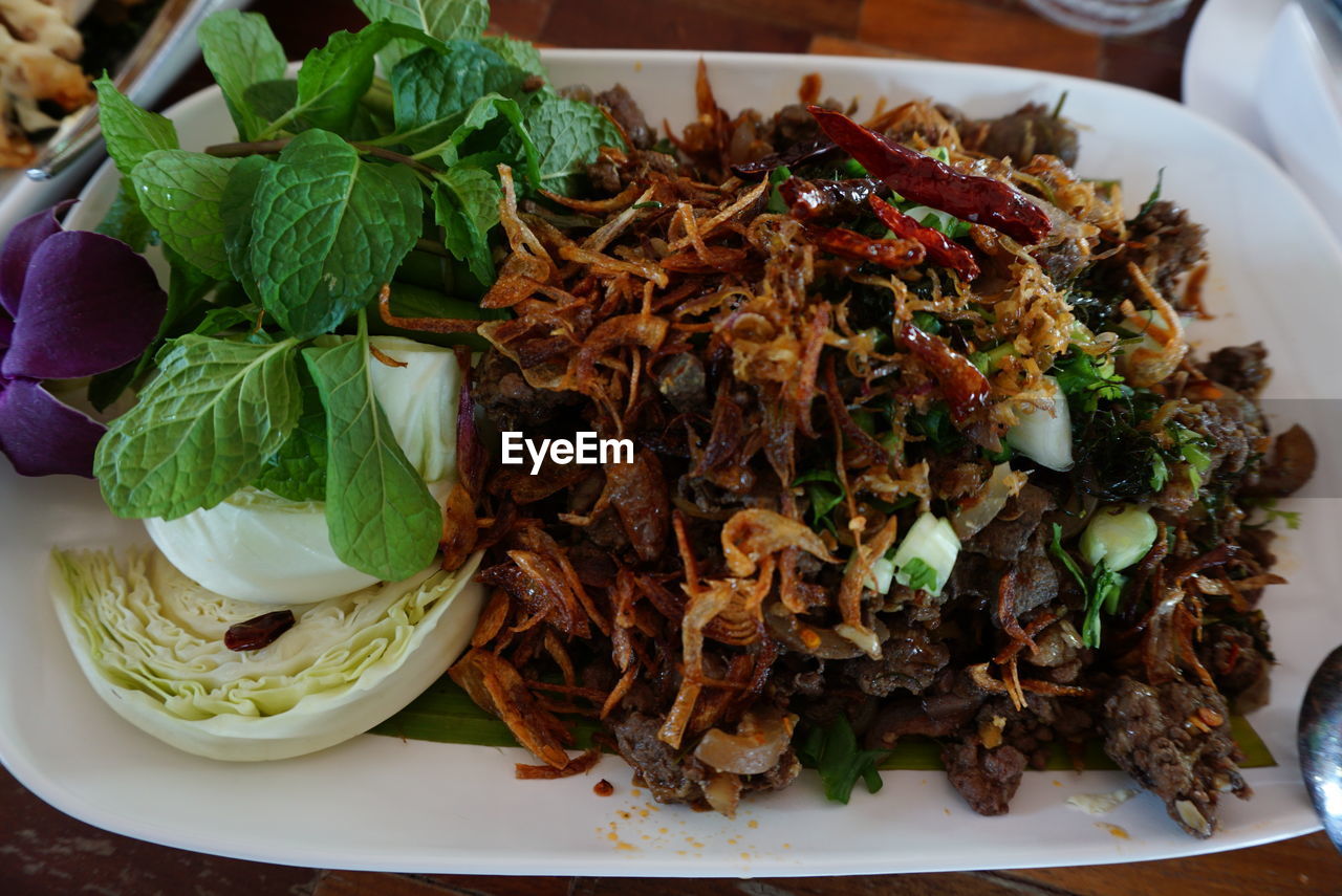 High angle view of spicy minced pork salad in plate
