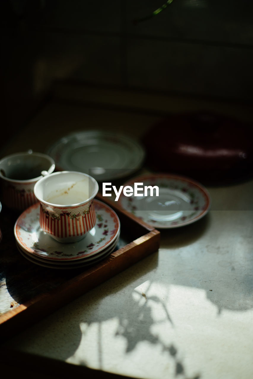 Close-up of old tea cup on table