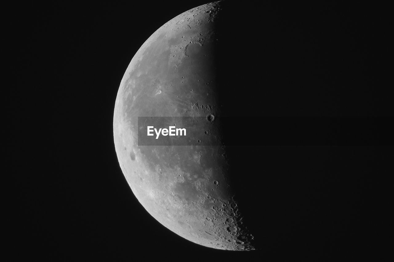 CLOSE-UP OF HALF MOON AGAINST SKY AT NIGHT