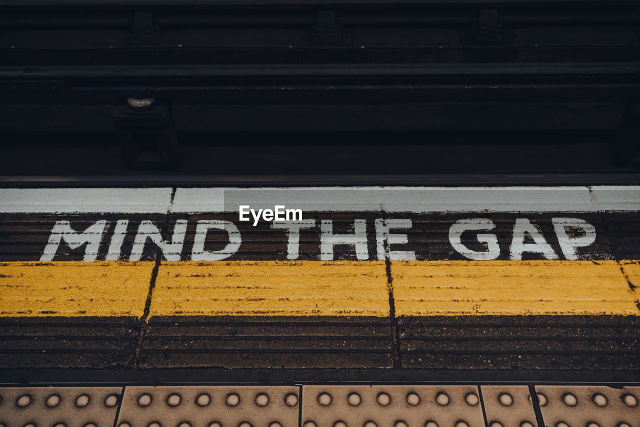 Mind the gap sign on the underground station platform in london, uk.