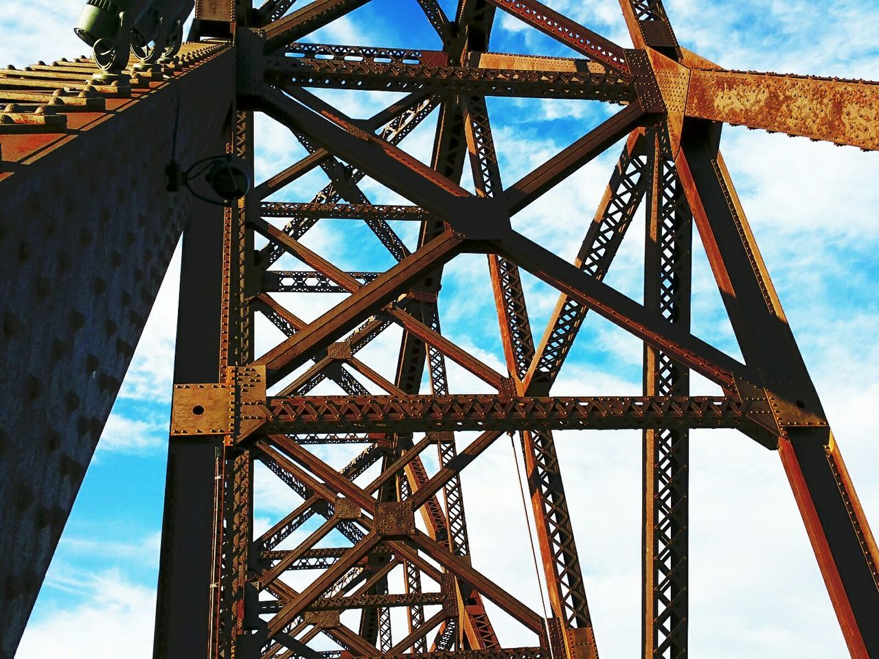 LOW ANGLE VIEW OF METALLIC BRIDGE