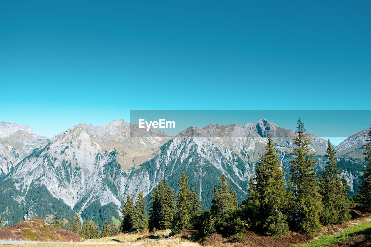 PANORAMIC VIEW OF MOUNTAINS AGAINST CLEAR BLUE SKY