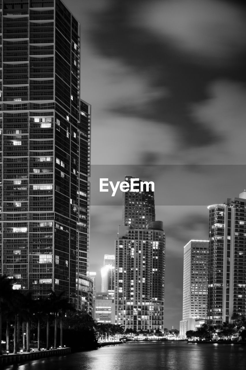 ILLUMINATED BUILDINGS AGAINST SKY AT NIGHT