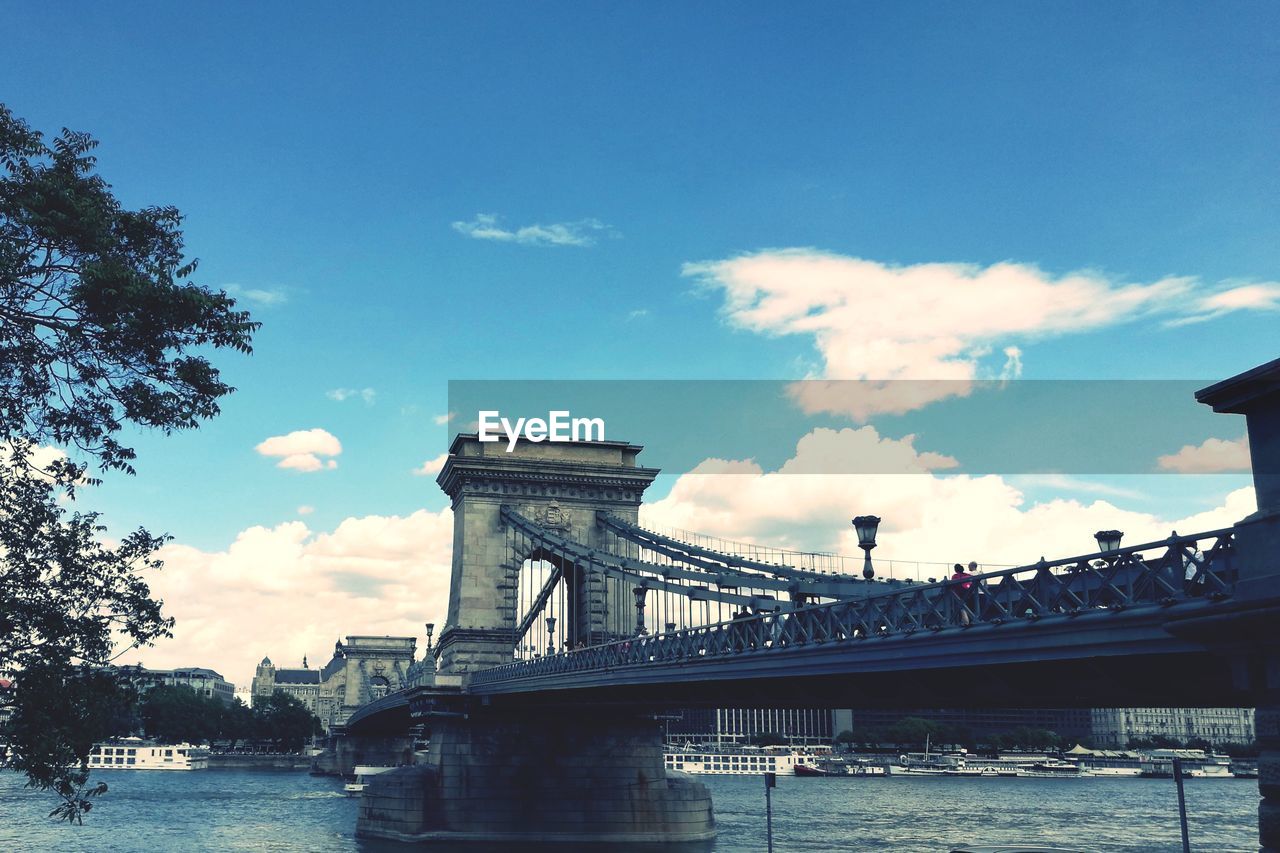 LOW ANGLE VIEW OF BRIDGE AGAINST CLOUDY SKY