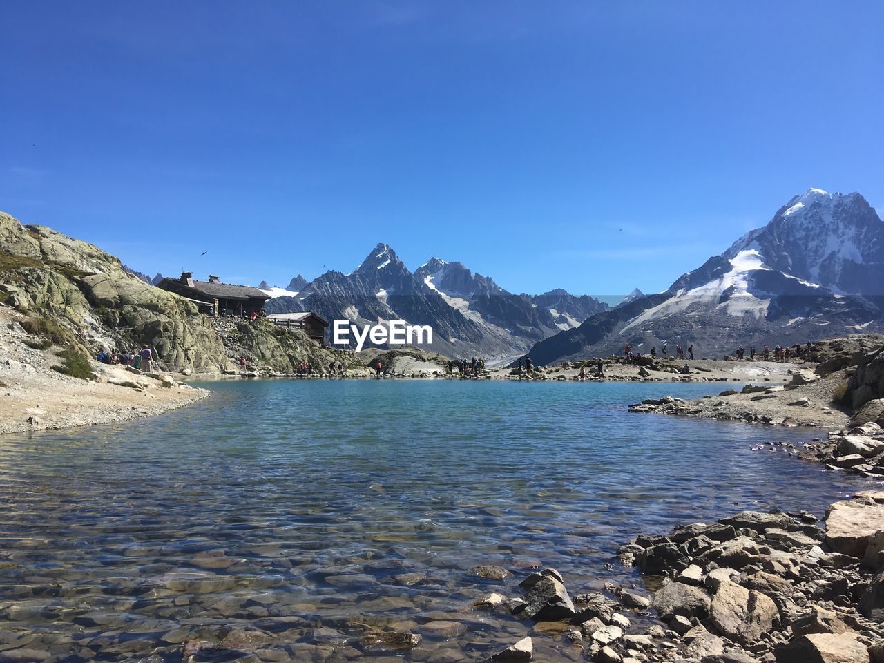 Scenic view of snowcapped mountains against clear blue sky