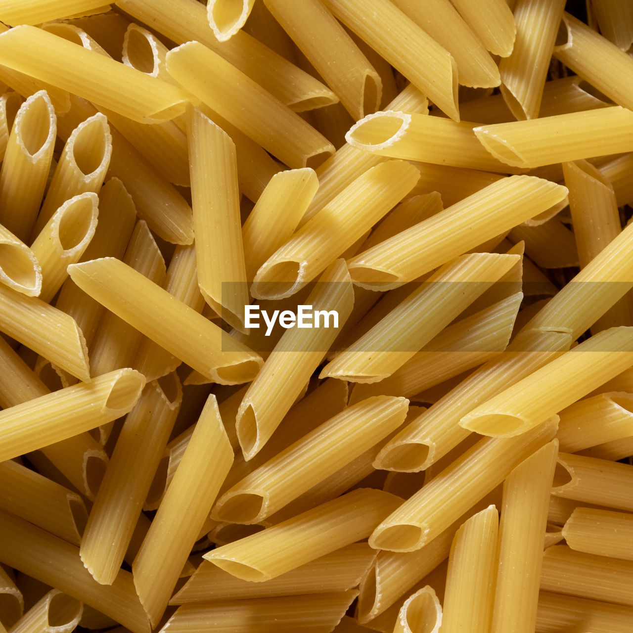 italian food, pasta, food, food and drink, raw food, large group of objects, freshness, healthy eating, indoors, penne, wellbeing, abundance, backgrounds, cuisine, yellow, no people, full frame, still life, close-up, produce, spaghetti, dish