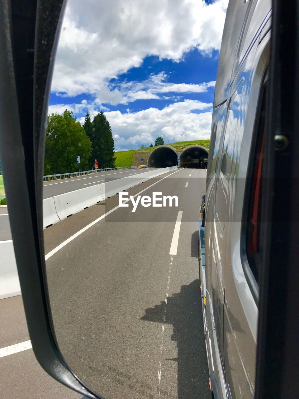 CARS ON ROAD AGAINST SKY SEEN THROUGH CAR WINDSHIELD