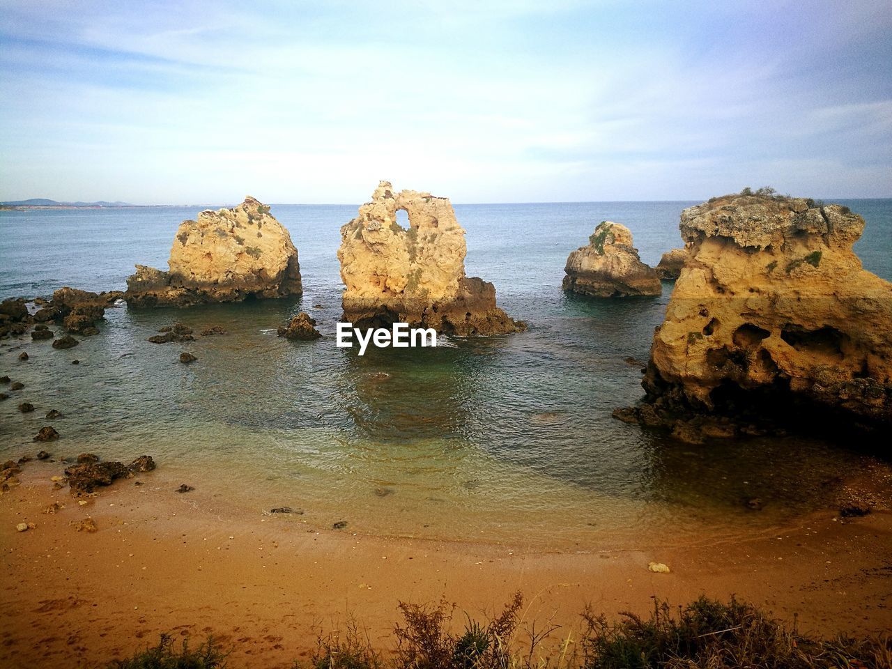 Rocks on beach against sky