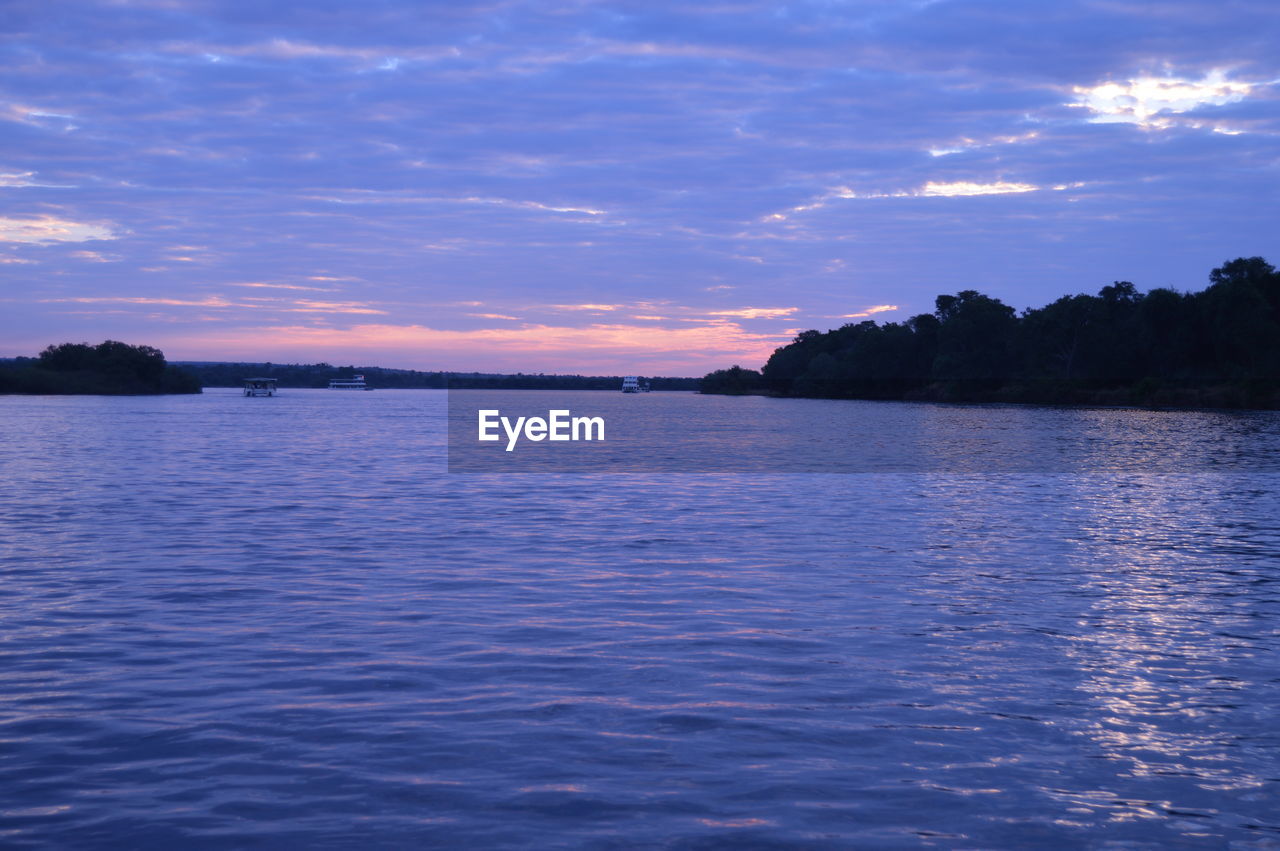 SCENIC VIEW OF LAKE AT SUNSET