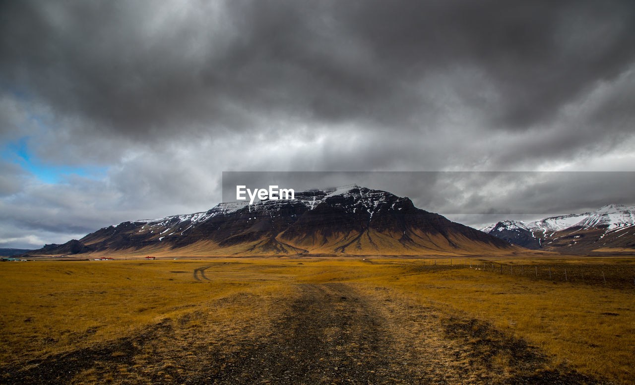 Scenic view of mountain against cloudy sky