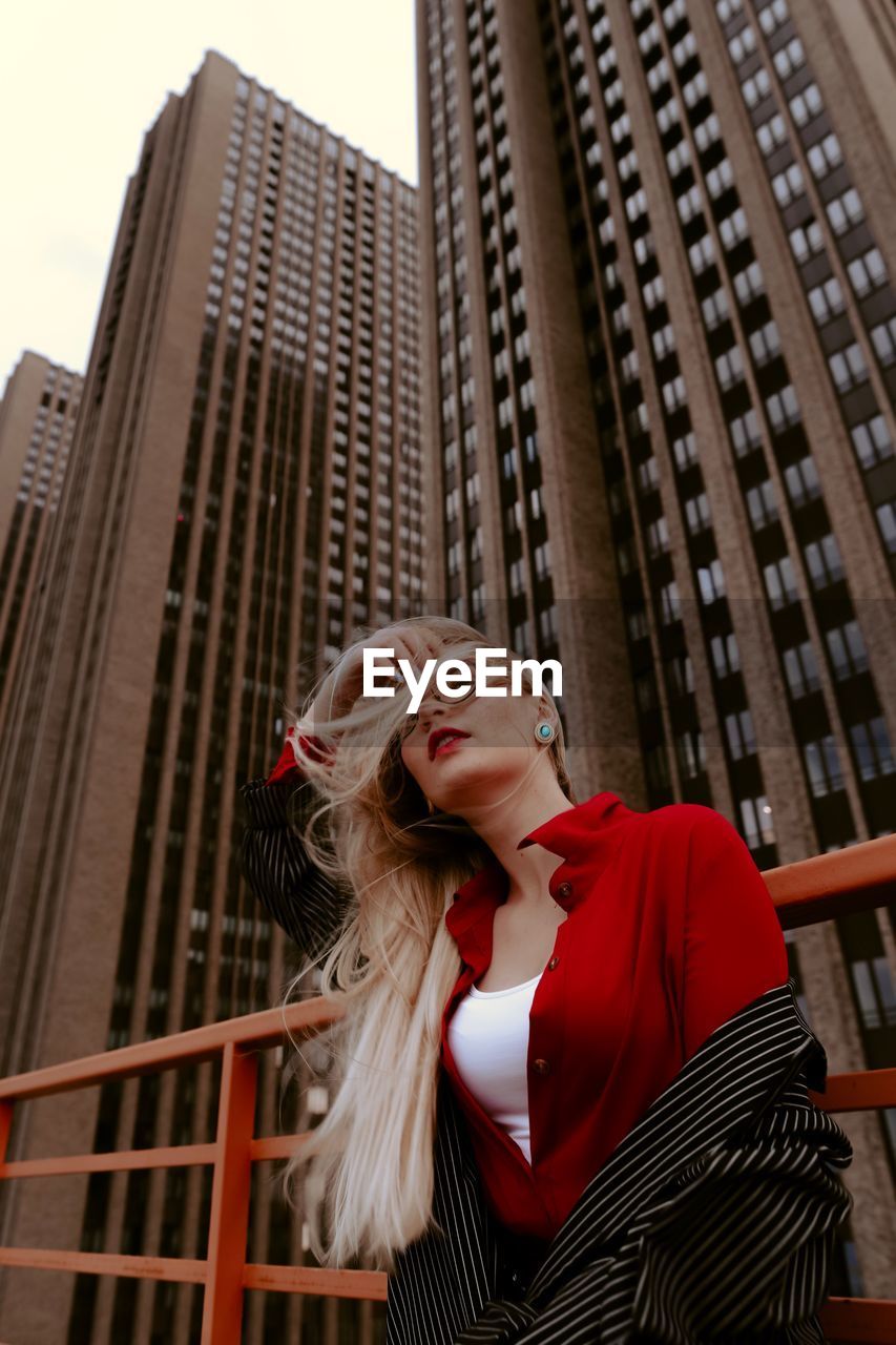 Beautiful woman against buildings in city