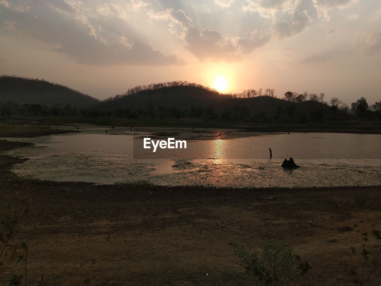 SCENIC VIEW OF LAKE AT SUNSET