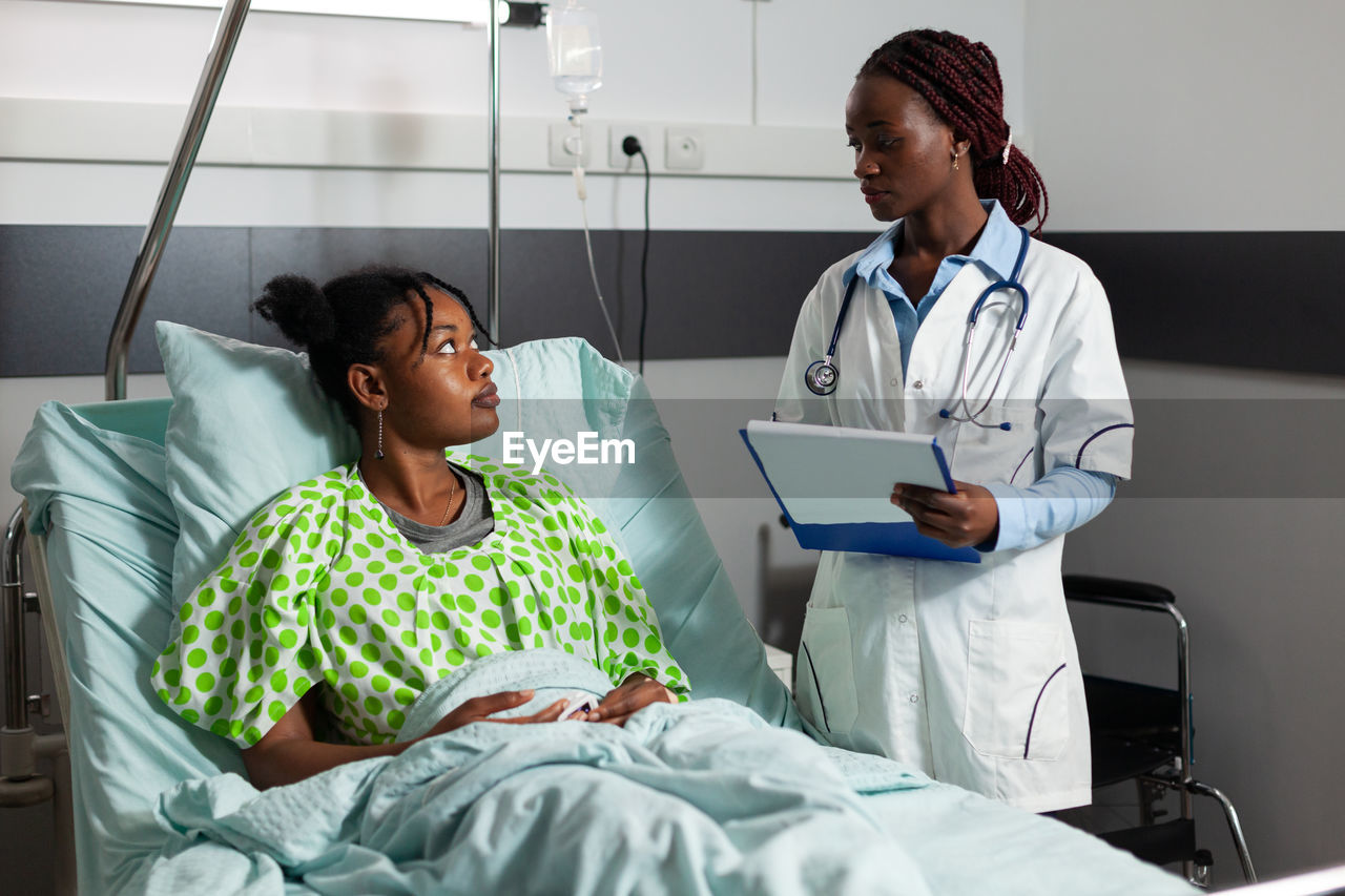 Female doctor examining patient in hospital