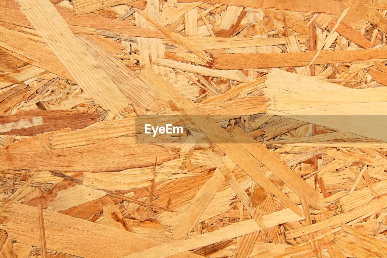 FULL FRAME SHOT OF HARDWOOD FLOOR AGAINST BLUE WALL