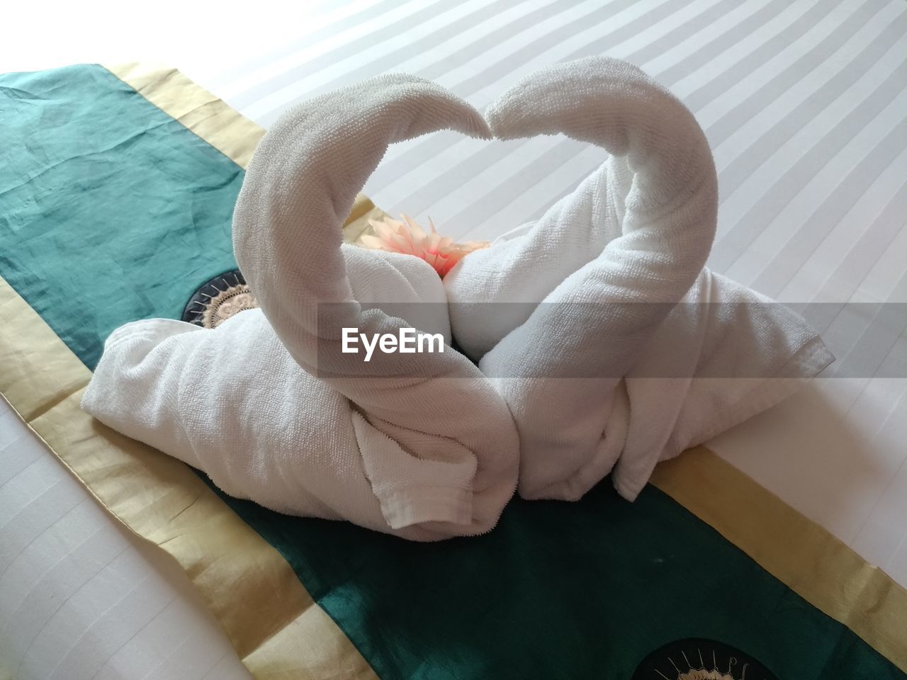 HIGH ANGLE VIEW OF HEART SHAPE MADE ON BED
