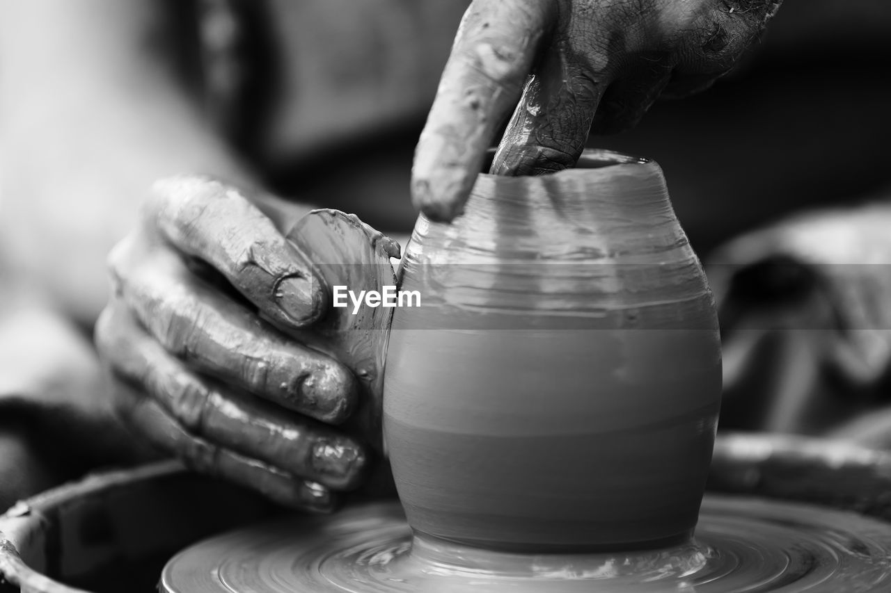 Hands of a potter. potter making ceramic pot on the pottery wheel