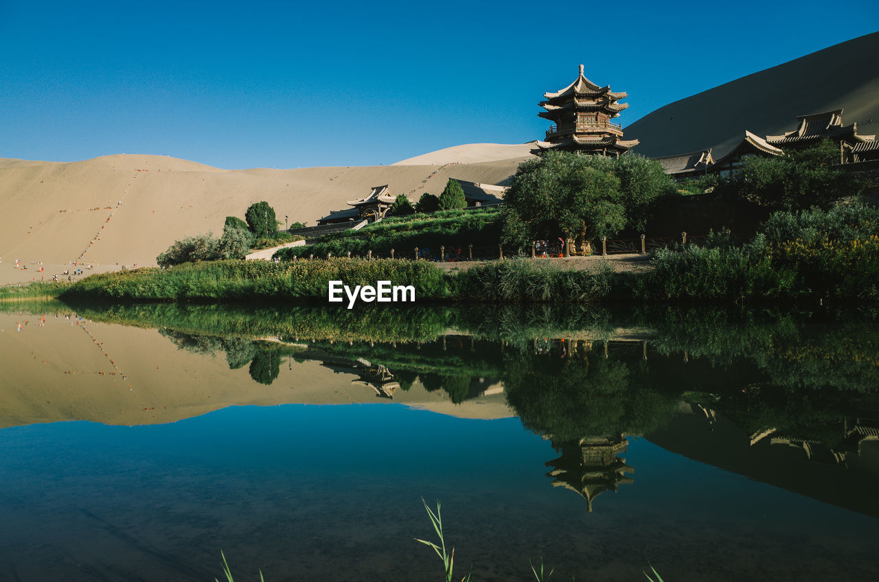 Scenic view of crescent lake against sky