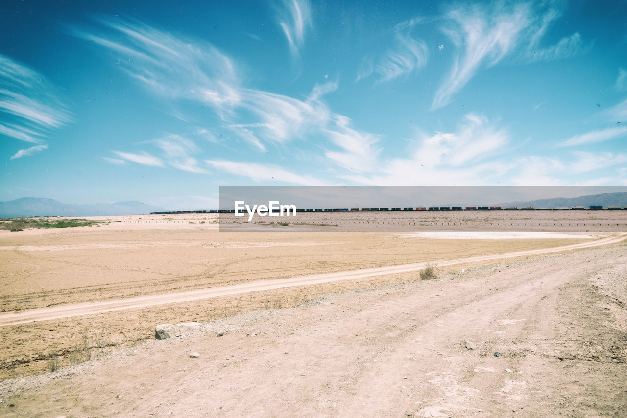 Scenic view of landscape against blue sky