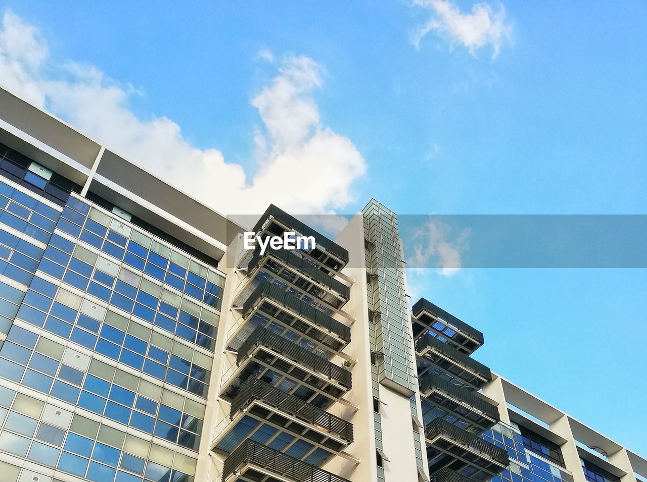 Low angle view of modern building against blue sky